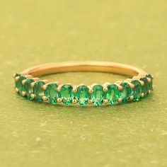 14k Emerald Band Ring, Half Eternity Wedding Band Women, Oval Cut Gemstone Ring, Dainty Stacking Ring, Green Gemstone Ring, Mother Day Gifts Item Detail: Material: 925 Sterling Silver, Yellow Gold, Rose Gold Gemstone: Emerald ( Lab Created CZ ) Shape: Oval Size: 3x5mm Color: Green  Stone Weight: 2.15 Ct approx. NOTE: We use good quality gemstone. Therefore they might vary a little in color, hue and reflection. But I assure you will like it. We use base material 925 solid silver then gold plating or rose gold on the ring. If you will do care the ring of gold plating it will go last longer. SHOP GemPlaceJaipur> https://www.etsy.com/in-en/shop/Gemplacejaipur FAST, FREE SHIPPING AND HANDLING TIME Handling Time: We take handling time of 3 Business Day from the date of receipt of the payment aft Classic Oval Stackable Emerald Ring, Oval Emerald Stackable Rings, Oval Gemstone Eternity Band For Promise Ring, Stackable Oval Emerald Wedding Ring, Oval Stackable Emerald Wedding Ring, Oval Stackable Anniversary Rings, Oval Eternity Band With Prong Setting For Promise, Anniversary Oval Stackable Rings, Stackable Oval Crystal Ring For Promise