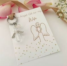 an angel gift for my wife on a card with a keychain and flowers