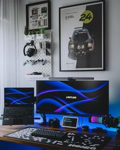 two computer monitors sitting on top of a wooden desk