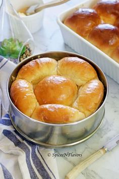 bread rolls in a metal pan on a table