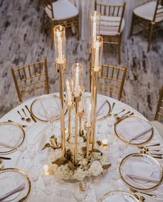 the centerpieces are surrounded by candles and flowers