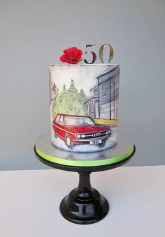 a birthday cake with an image of a red car on the front and number 50 on the back