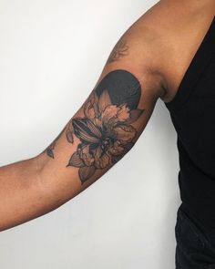 a man with a flower tattoo on his arm