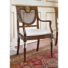 a wooden chair sitting on top of a rug