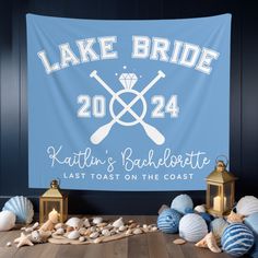 the lake bride banner is next to lanterns and seashells in front of it