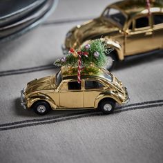 a gold car with a christmas tree on top