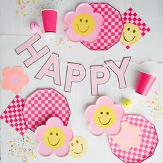 paper flowers and cupcakes with the words happy on them