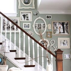 the stairs are decorated with pictures and frames