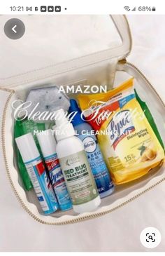 an open white bag with all the contents in it, including hand sanitizers and mouthwashes