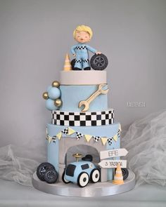 a three tiered cake with a boy on top