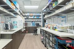 the inside of a medical office with lots of shelves and drawers on each side of the room