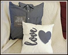 two pillows that have been placed on a couch with the words love written on them