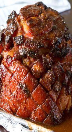 some kind of meat sitting on top of a foil pan covered in bbq sauce