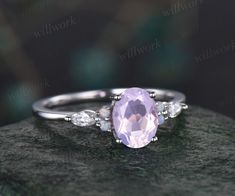 - Metal: Solid gold(10K/14K/18K white/yellow/rose gold),925 sterling silver,platinum available- Main Stone: 6x8mm oval cut natural Lavender Amethyst- Accent Stone: moissanites and lab opals- Wedding Band Stone: amethysts and moissanites- Band Width: 1.4mm- Can be personalized: Yes Elegant White Amethyst Wedding Ring, Oval Amethyst Ring With Cubic Zirconia, Dainty Oval Amethyst Wedding Ring, White Gold Oval Amethyst Promise Ring, Oval Amethyst Promise Ring In White Gold, White Gold Oval Amethyst Ring For Wedding, Elegant Purple Opal Ring For Anniversary, Elegant Purple Opal Anniversary Ring, Lavender Amethyst Ring In Oval Sterling Silver