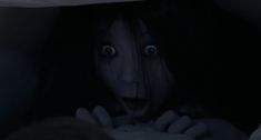 a creepy looking woman with her mouth open in the dark