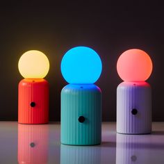 three different colored lights sitting next to each other