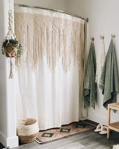 a bathroom with two towels hanging on the wall next to a bathtub and rug