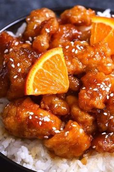 orange chicken with rice and sesame seeds in a bowl