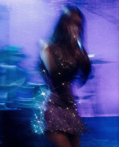 a blurry photo of a woman in a short dress