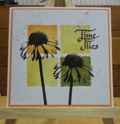 a card with two flowers on it and the words time flies written in cursive writing