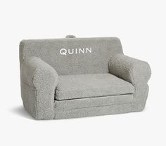 a grey chair with the word quinn on it's back and footrests