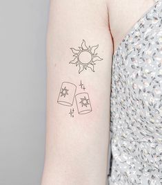 a woman with a tattoo on her arm has the sun and two books in it