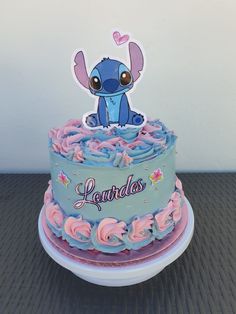 a blue and pink cake sitting on top of a table