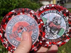 two red and black poker chips held in their hand with the words built - in dogs printed on them