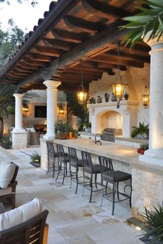 an outdoor kitchen and dining area is shown