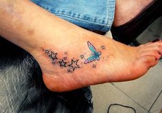 a woman's foot with stars and a butterfly tattoo on her left side ankle