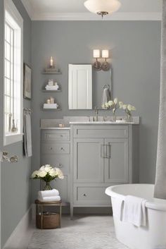 a white bath tub sitting under a bathroom mirror