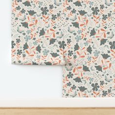 two pieces of wall paper with flowers and leaves on them, one is blue and the other is orange