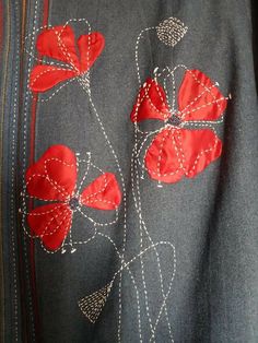 an embroidered jacket with red flowers on the front and back, along with white stitching