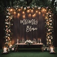 a table with candles and flowers on it next to a sign that says, mesmers brown