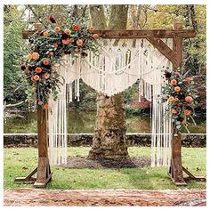 an outdoor wedding ceremony setup with macrame and orange flowers on the arborette