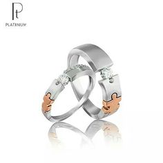 two wedding rings with diamond accents on each side and the words platinum written in gold