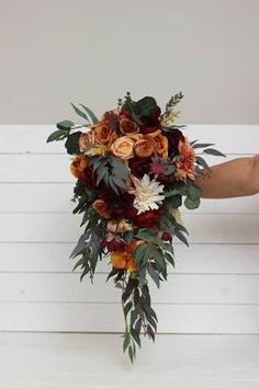 a bridal bouquet with orange and red flowers