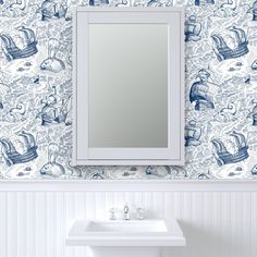 a white sink sitting under a bathroom mirror next to a wall mounted faucet