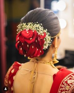 the back of a woman's head with red flowers in her hair and an instagram