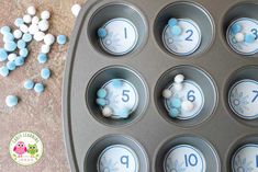 blue and white cupcakes in a muffin tin with the number nine on them