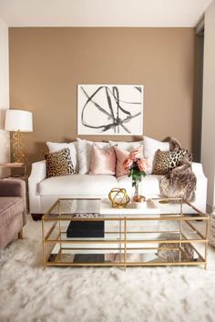 a living room filled with furniture and a painting on the wall above it's coffee table