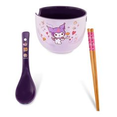 a purple cup and two chopsticks on a white surface with an animal design