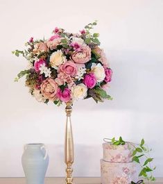 there is a vase with flowers on the table next to it and two other items