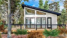 a small house in the woods surrounded by trees