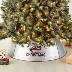 a christmas tree in a metal bucket with lights