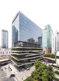 an aerial view of a city with tall buildings and people walking on the street in front of it