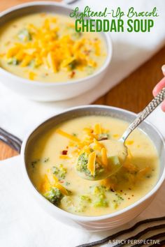 two bowls of broccoli cheddar soup with a spoon