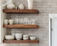 the shelves in the kitchen are filled with dishes