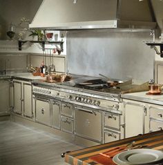 an industrial kitchen with stainless steel appliances and counter tops is pictured in this image from the front view