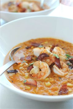 a bowl of soup with shrimp and corn